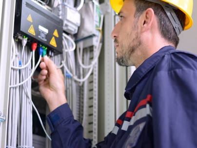 an electrician working on a panel